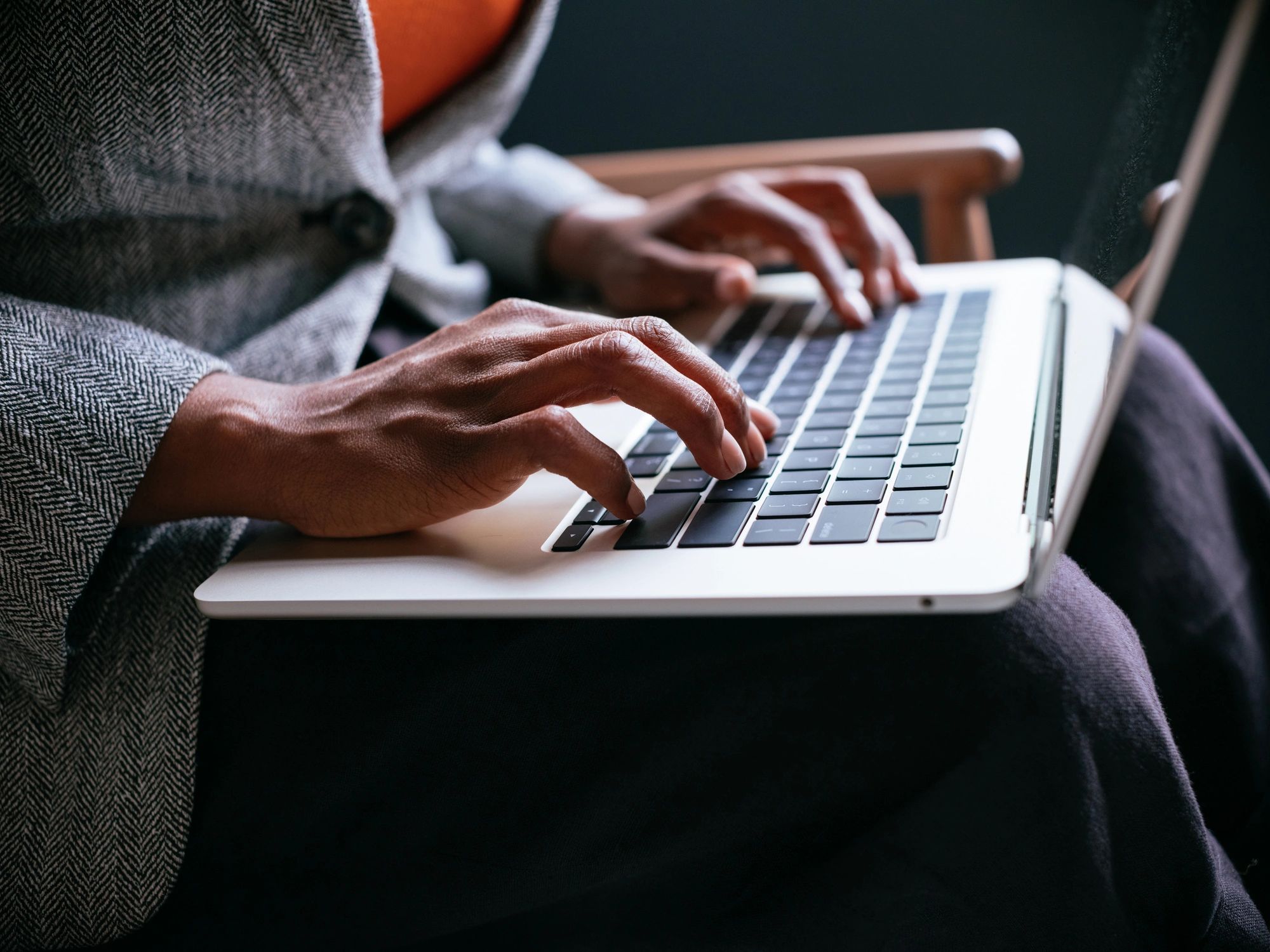 Professional working on a laptop keyboard