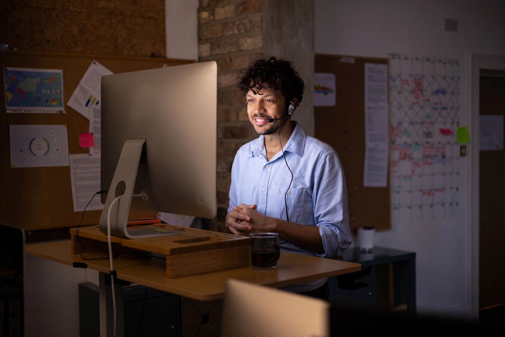 Remote tech support specialist working at a standing desk