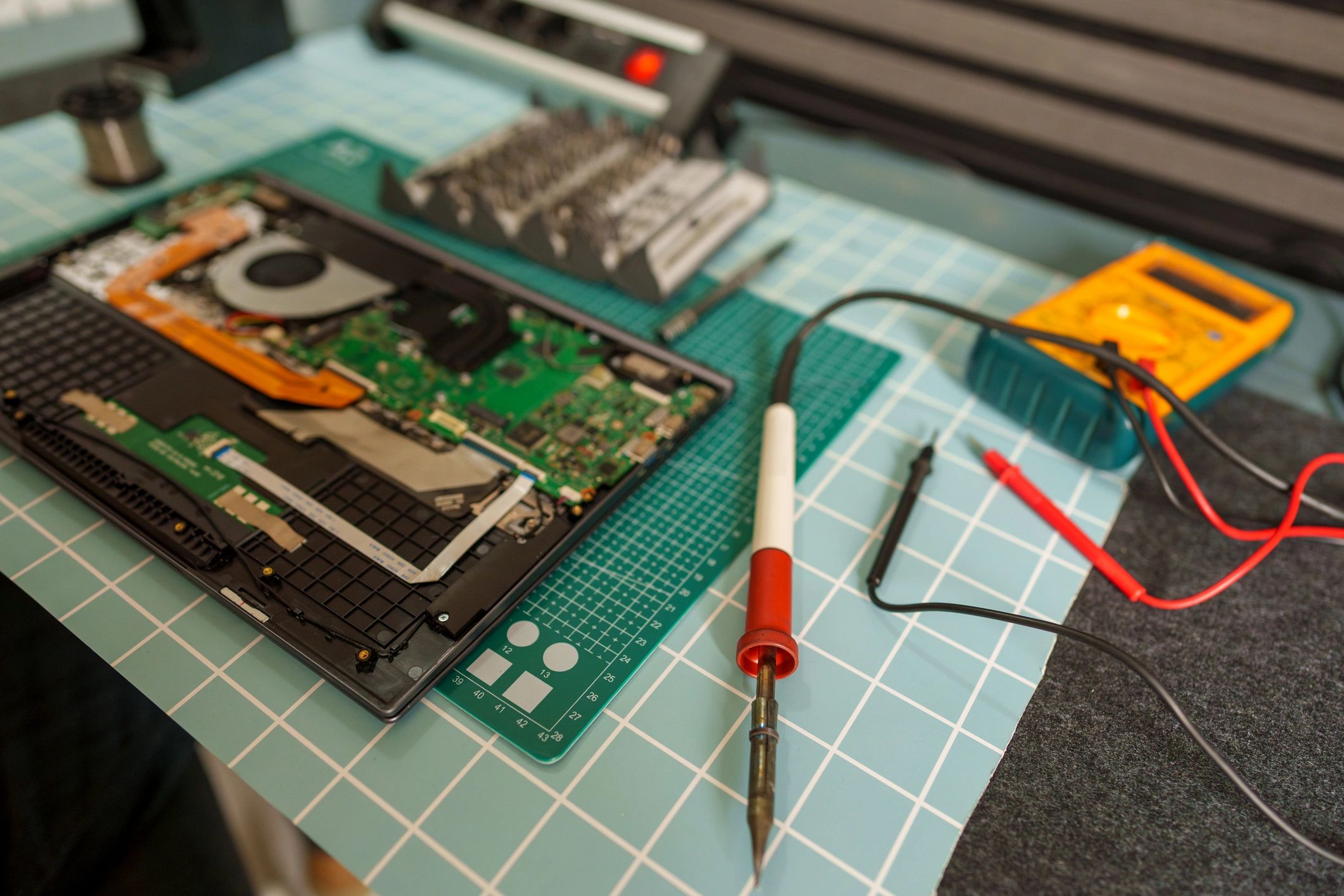 Technician repairing electronic motherboard components