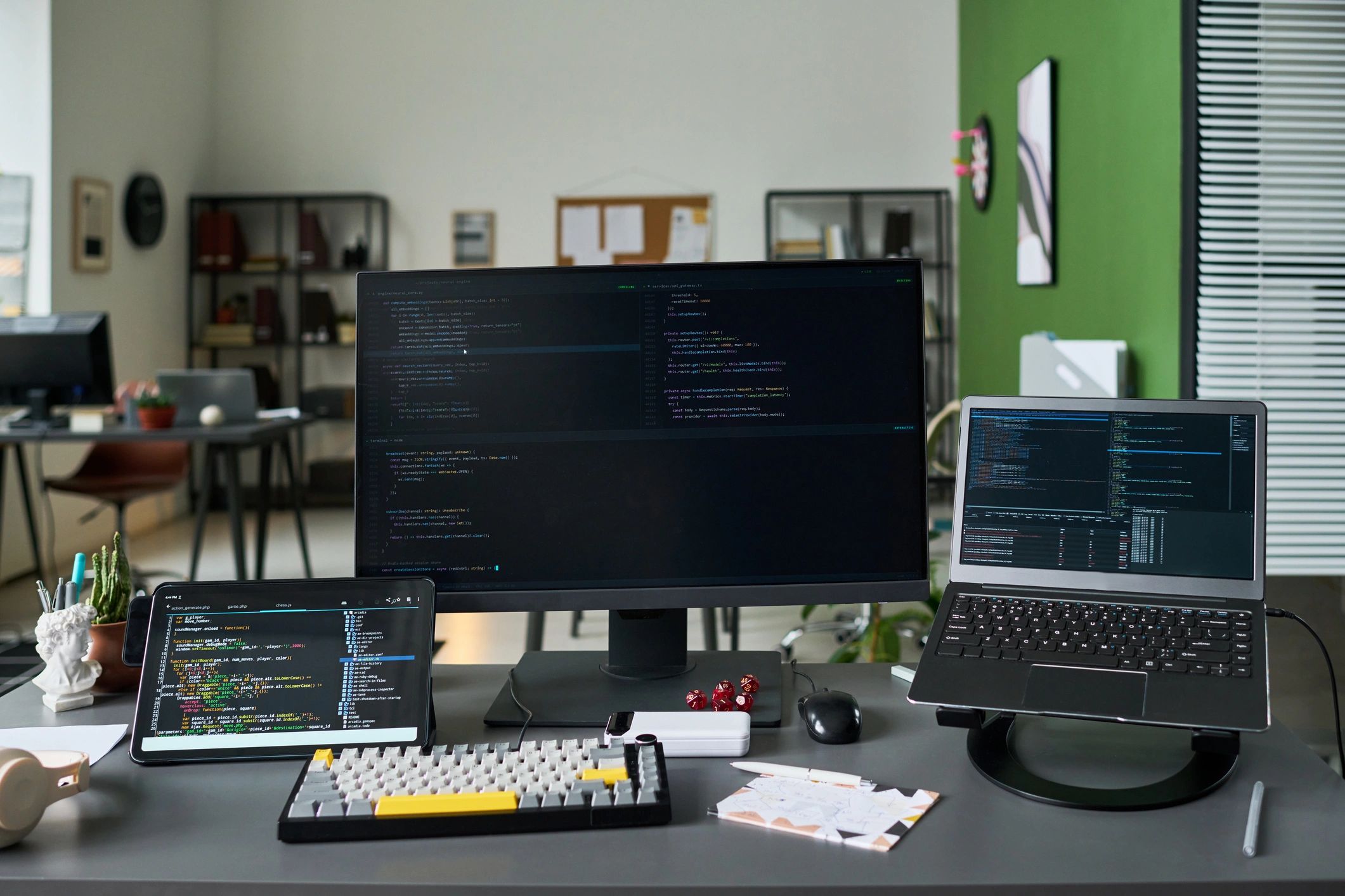 Technology workspace with code displayed on multiple screens